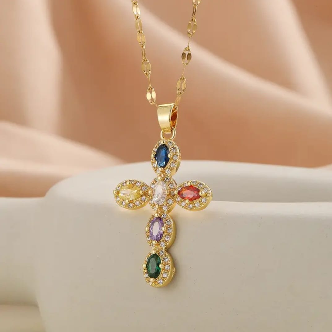 This elegant necklace blends timeless symbolism with chic French-inspired design. The gold-plated cross pendant is adorned with luminous oval rhinestones, arranged to catch the light with refined brilliance.