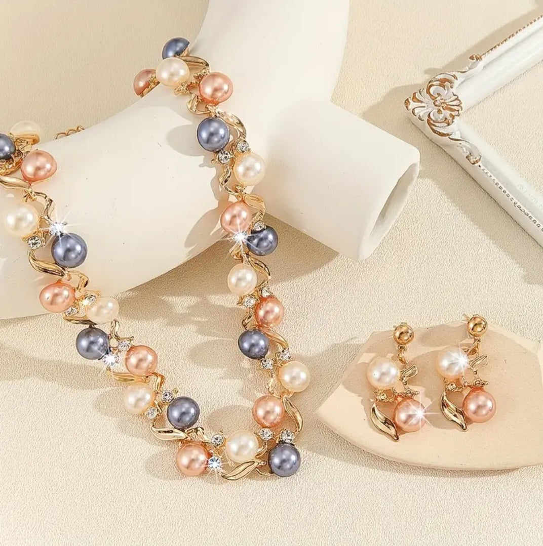 The necklace features layers of faux pearls that shimmer with a soft, classic luster, perfectly complemented by delicate detailing in gold‑plated zinc alloy. Sparkling rhinestones are carefully placed throughout, adding just the right amount of brilliance without overpowering the refined design.