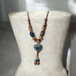 This ceramic bead necklace is designed to be both charming and distinctive, making it a perfect centerpiece for your collection. Strung along a smooth cord, the necklace features polished ceramic beads that create a balanced rhythm of texture and shine.