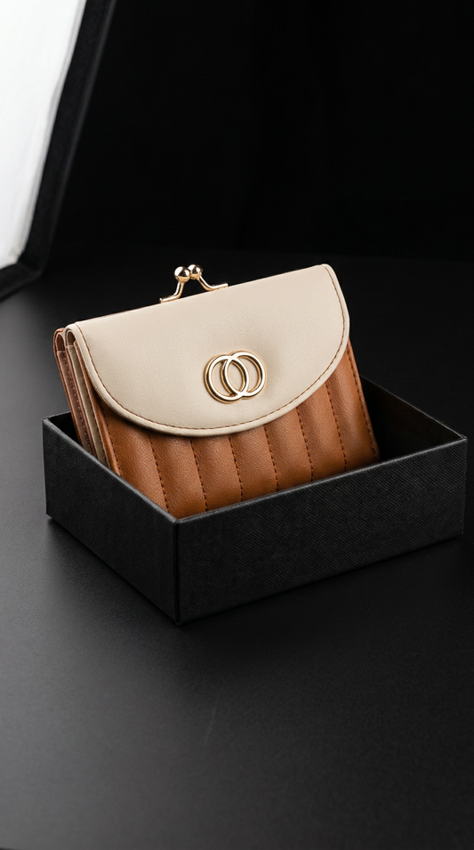 This ladies’ two-tone purse (13 x 9 cm) is designed with elegant gold clip and detailing for a refined finish. Compact yet functional, it securely holds coins, notes, and up to 5 bank cards