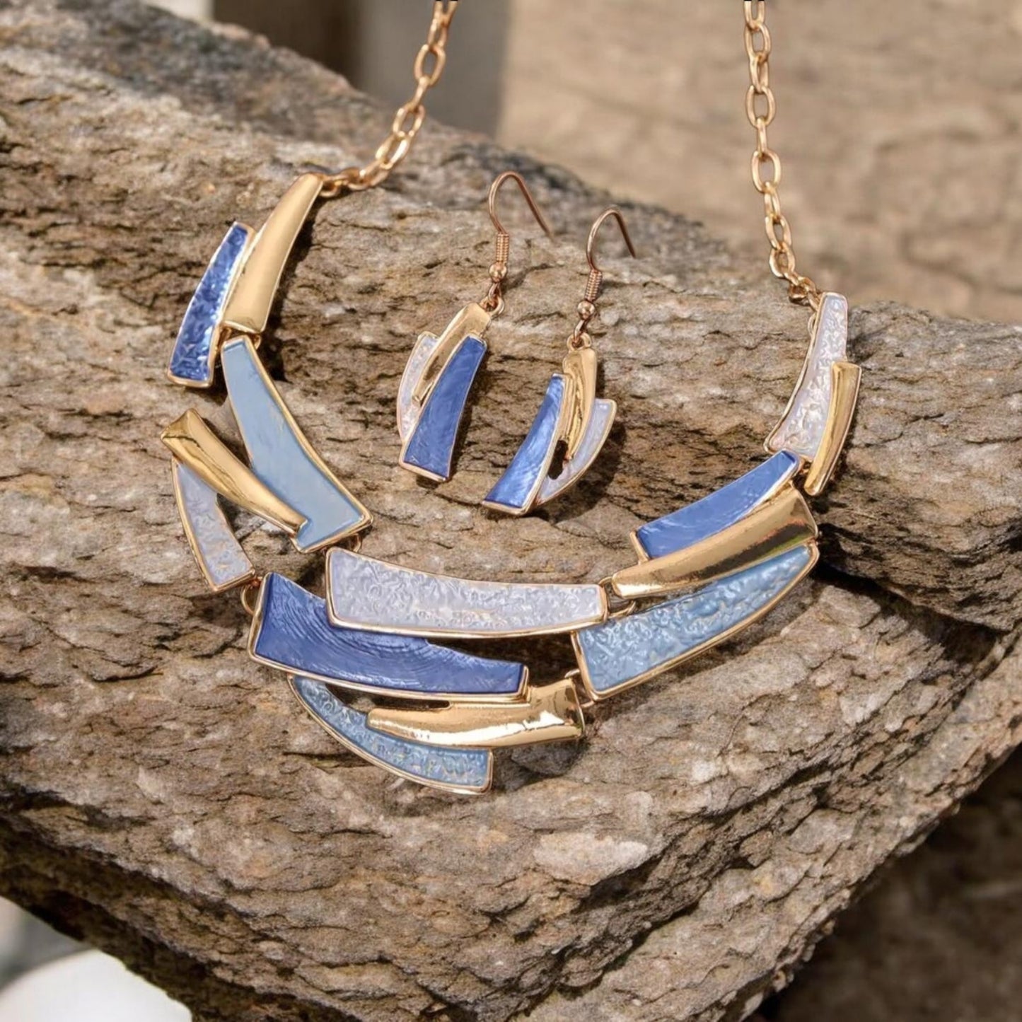 This stylish 2-piece set features a handmade gold-plated necklace and matching bracelet, both crafted from durable zinc alloy with warm blue tones.