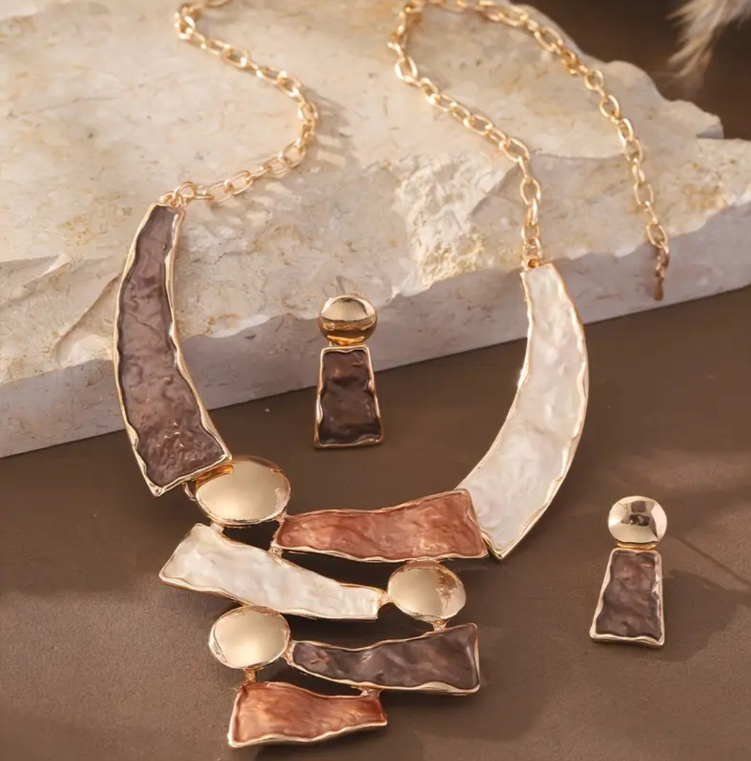 This stylish 2-piece set features a handmade gold-plated necklace and matching bracelet, both crafted from durable zinc alloy with warm brown tones.