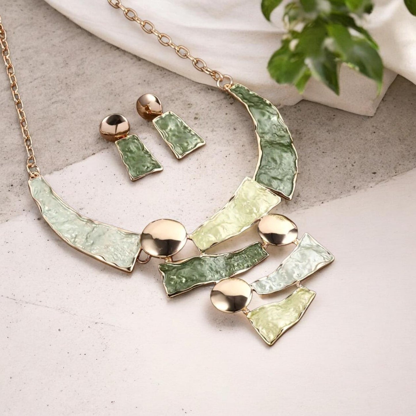 This stylish 2-piece set features a handmade gold-plated necklace and matching bracelet, both crafted from durable zinc alloy with warm green tones.