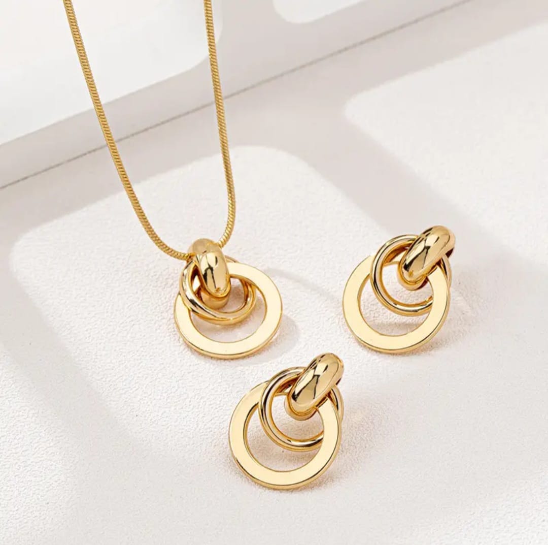 Gold necklace and matching earrings, designed with elegant circular elements