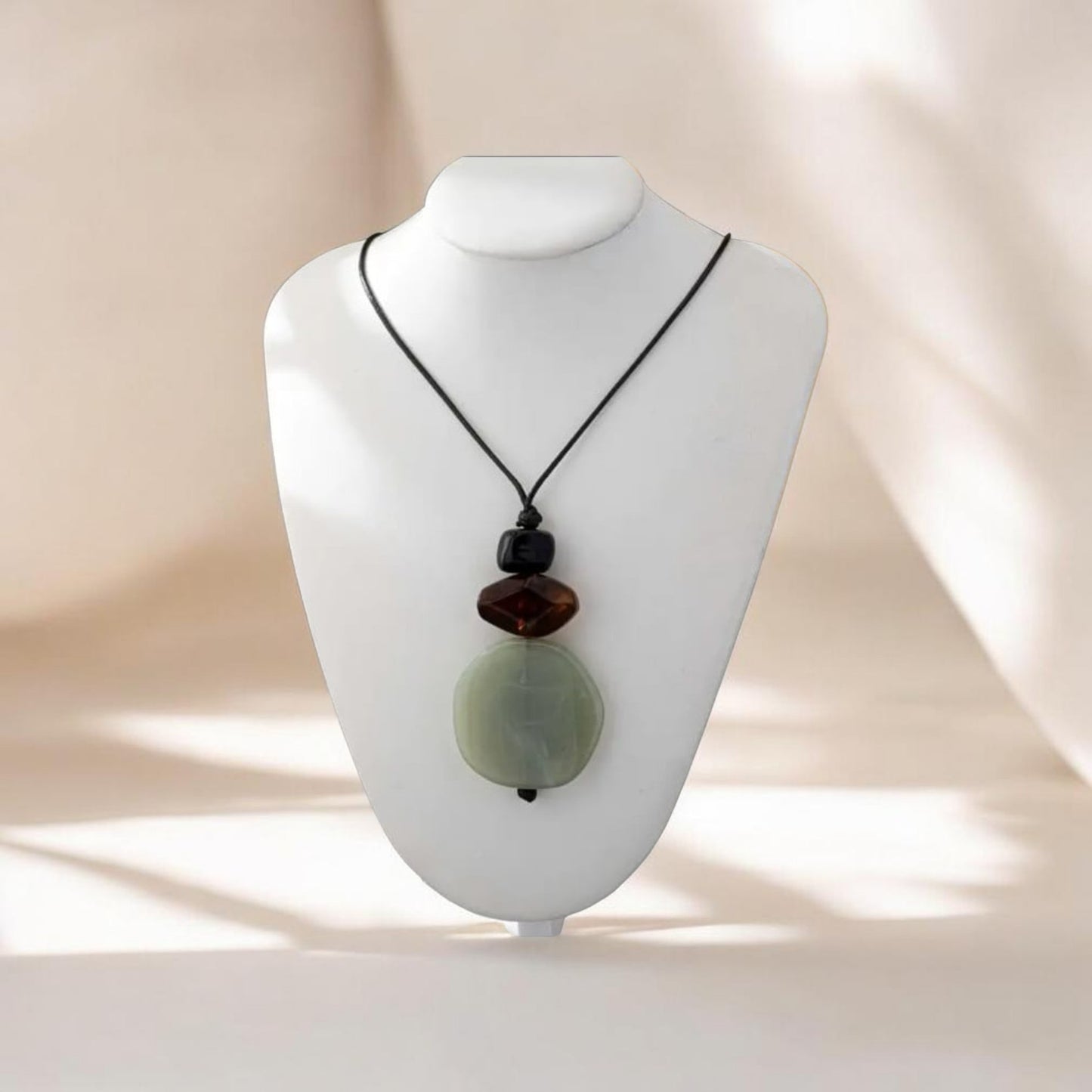 This refined piece showcases handmade craftsmanship with a unique resin pendant tied onto a durable cord necklace. The harmonious blend of green tones evoke natural beauty, symbolizing balance and earth-inspired elegance.