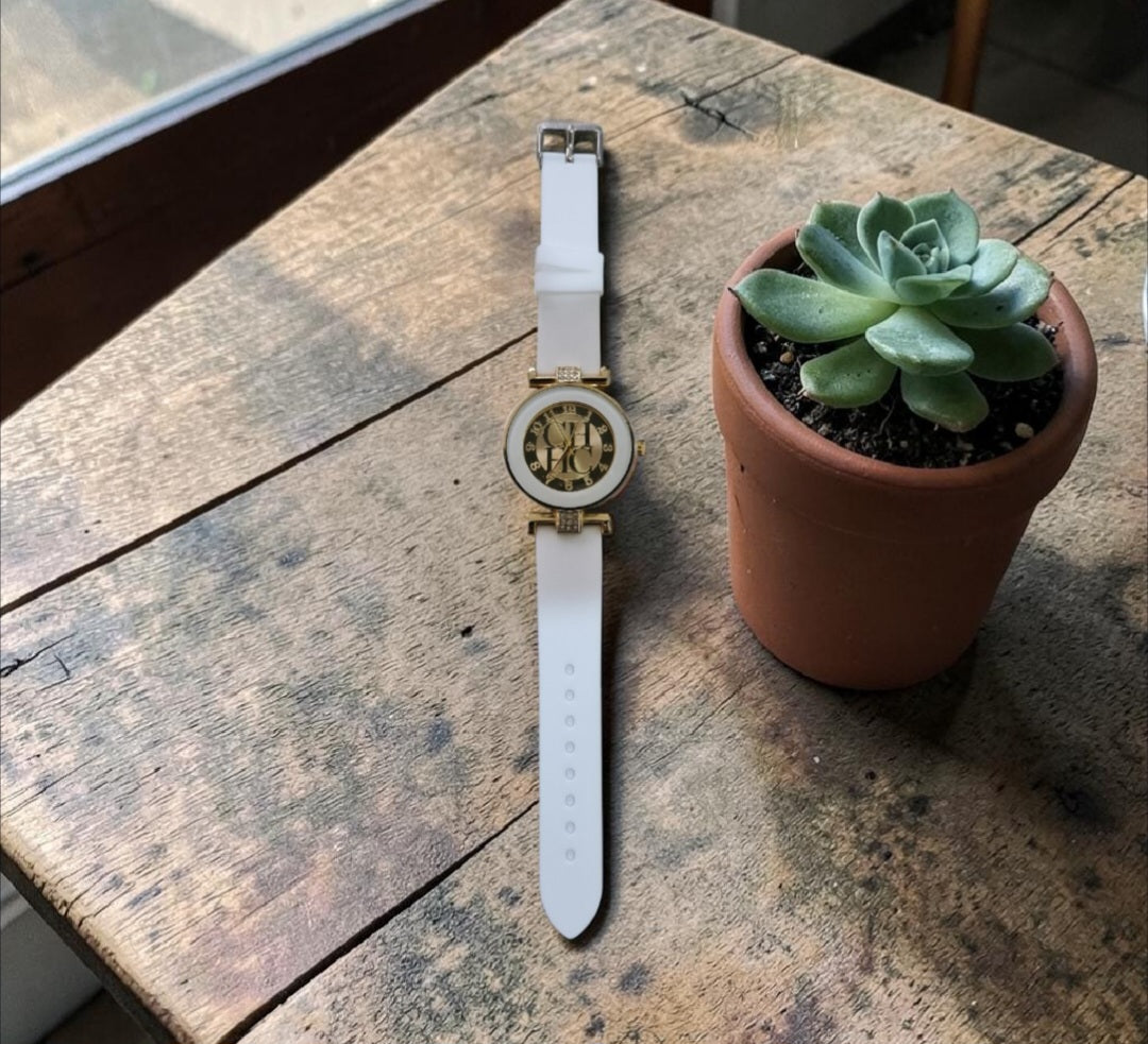 Add a touch of elegance to your everyday look with this ladies’ casual watch. Featuring a radiant gold face and a comfortable rubberized band, it’s available in white to suit your style. The band is accented with a subtle touch of diamante, giving it just the right amount of sparkle. Perfect for casual wear yet chic enough to elevate any outfit, this watch blends practicality with feminine charm.