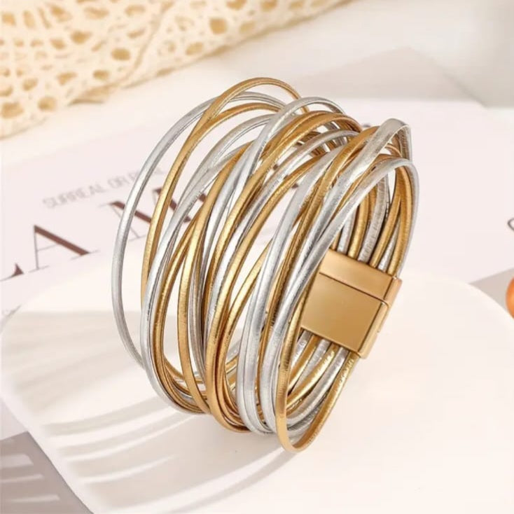  Faux leather multi‑layer bracelet, designed to make every day styling effortless. Featuring stacked layers in a versatile mix of textures and colors. 