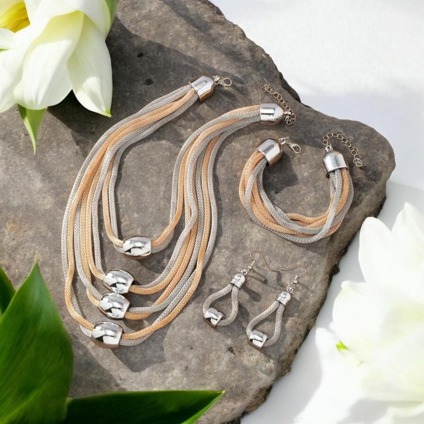 This sophisticated 3-piece set includes a multi-layer rope necklace, bracelet, and matching earrings, all meticulously handcrafted for a unique finish. Featuring intertwined strands of shimmering gold rope and sleek silver rope, the design creates a striking contrast that embodies elegance and modern artistry.