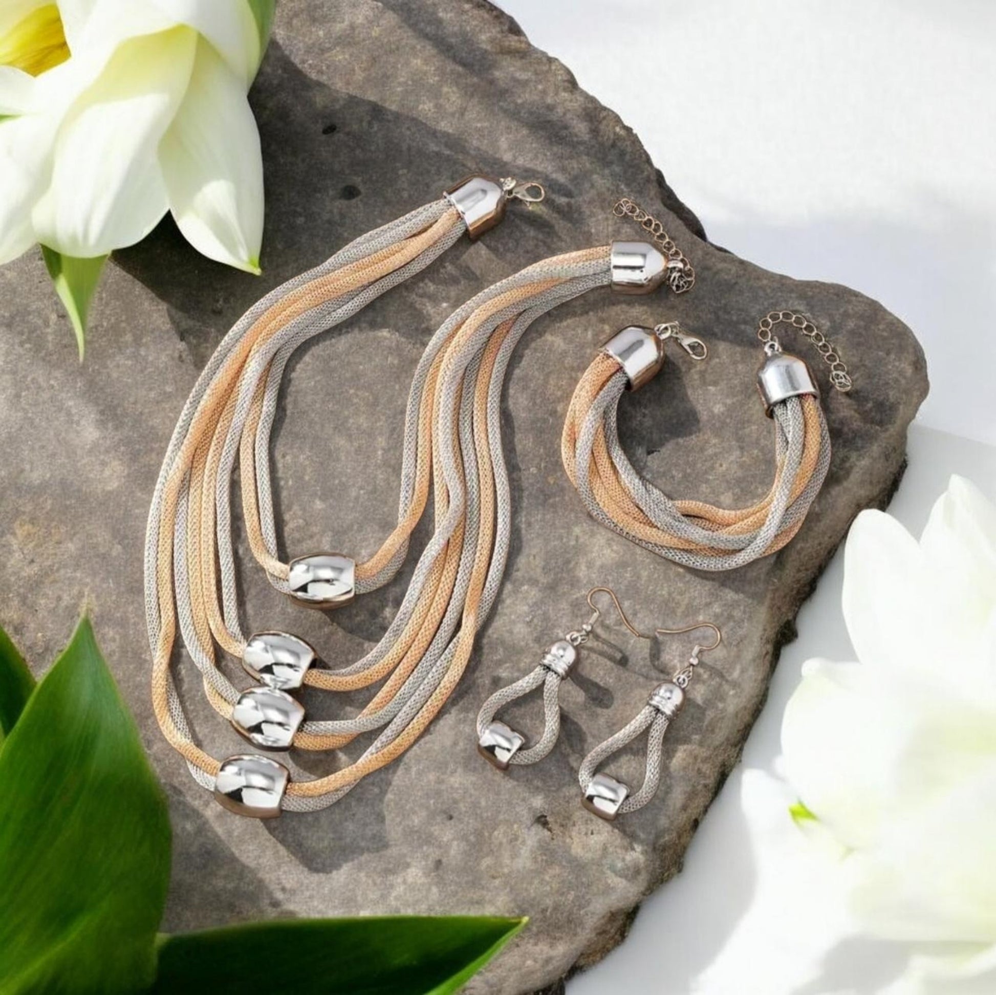 This sophisticated 3-piece set includes a multi-layer rope necklace, bracelet, and matching earrings, all meticulously handcrafted for a unique finish. Featuring intertwined strands of shimmering gold rope and sleek silver rope, the design creates a striking contrast that embodies elegance and modern artistry.